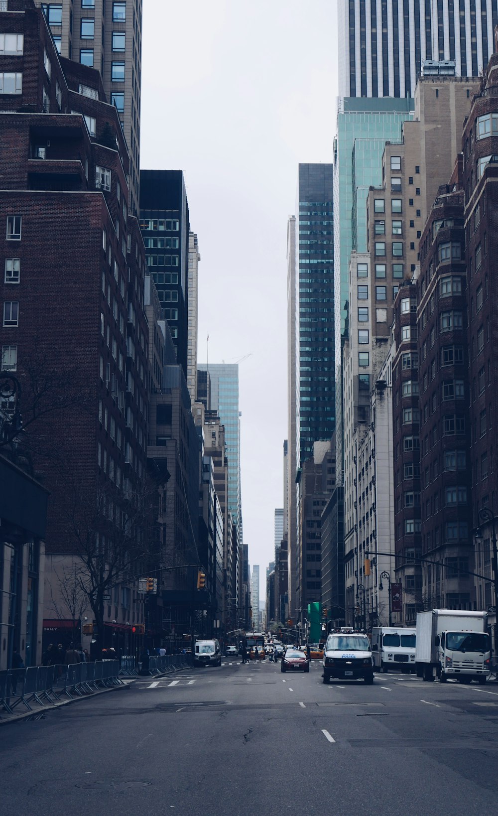 vehicles on road between high rise buildings