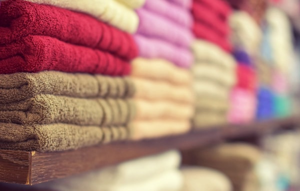 Colorful folded towels stacked on shelves