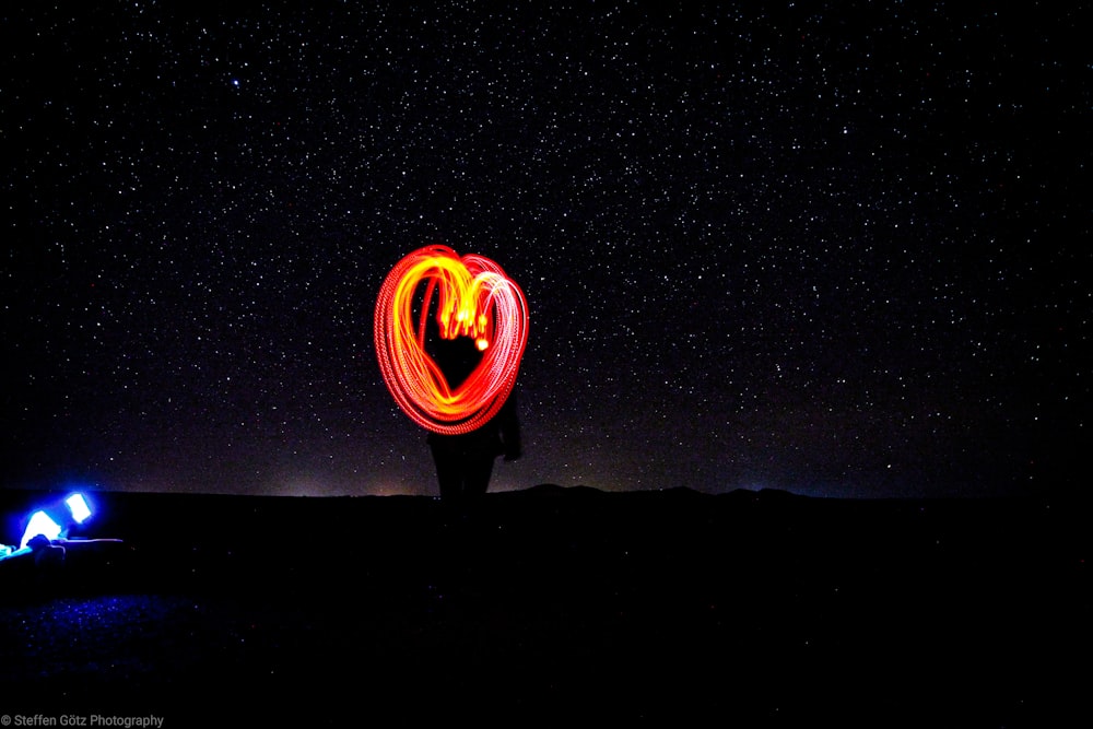 a couple of people that are standing in the dark