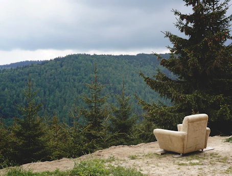 gray fabric sofa armchair in mountain during daytime