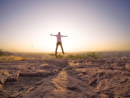 man jumping under white sky