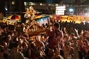 A lively street festival in Tokyo with lanterns and traditional costumes.