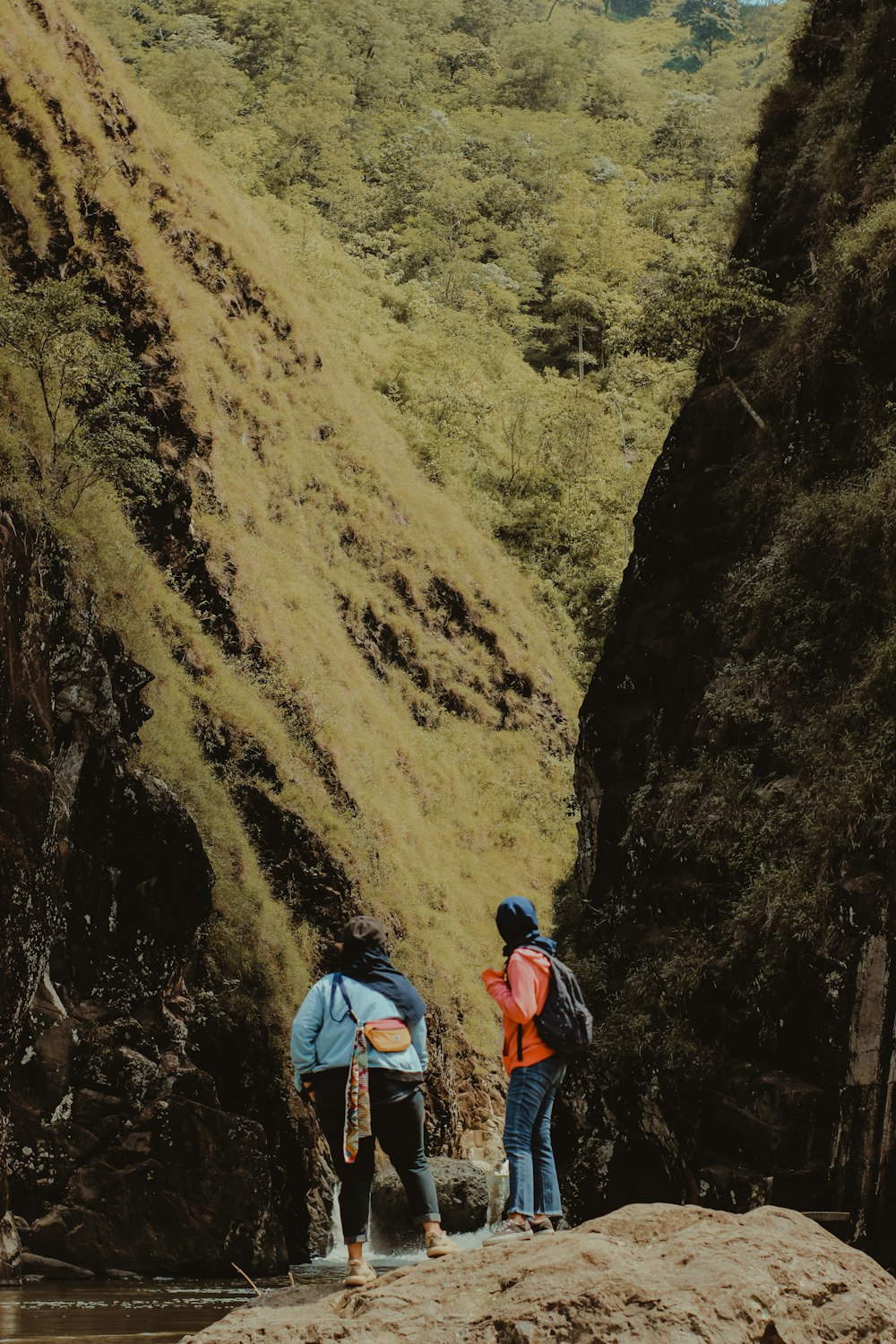 two women standing on rock