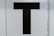 black letter T text
