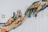 two human hands painting