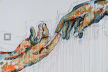 two human hands painting