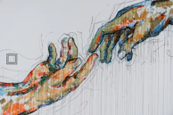 two human hands painting