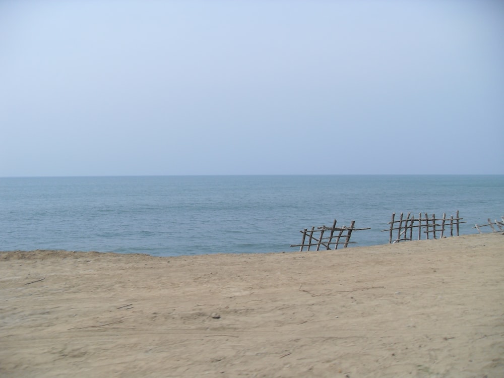 brown fence near ocean