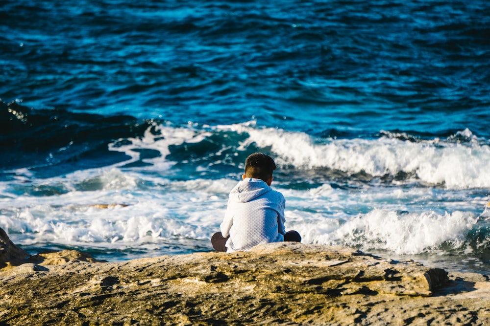 person sitting on shoreline