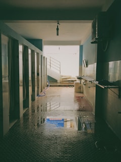 Interior facility featuring individual bathrooms and shower area with warm lighting and cleanliness.