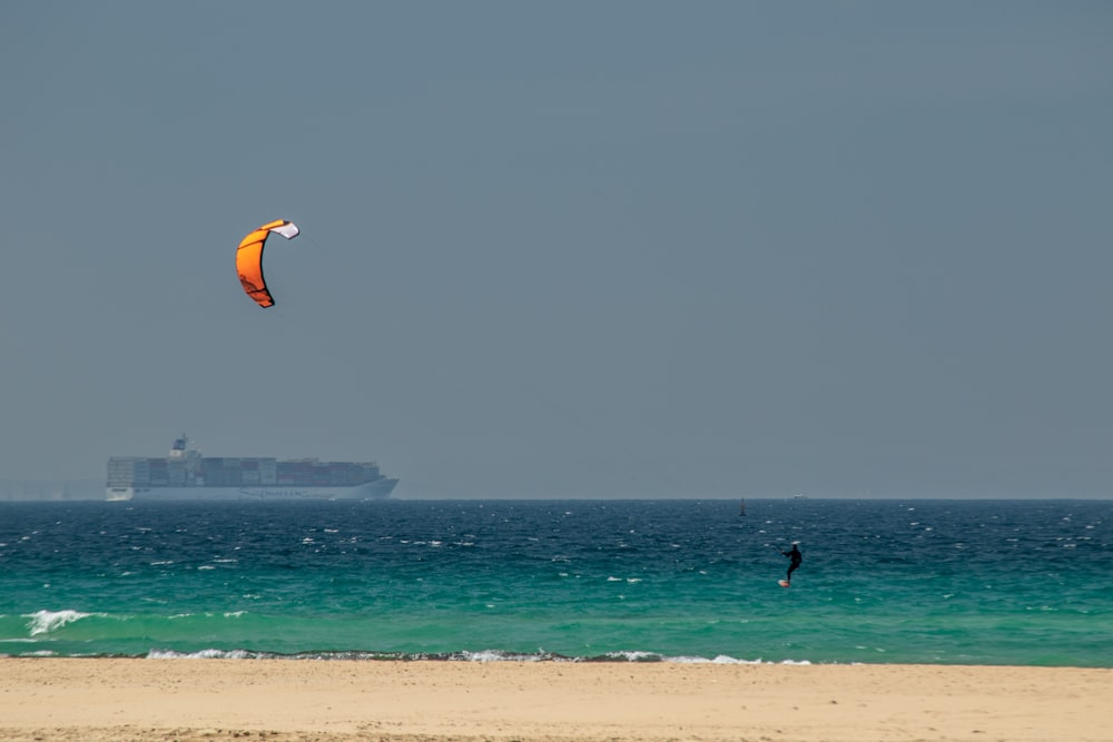 man riding kite skateboarding