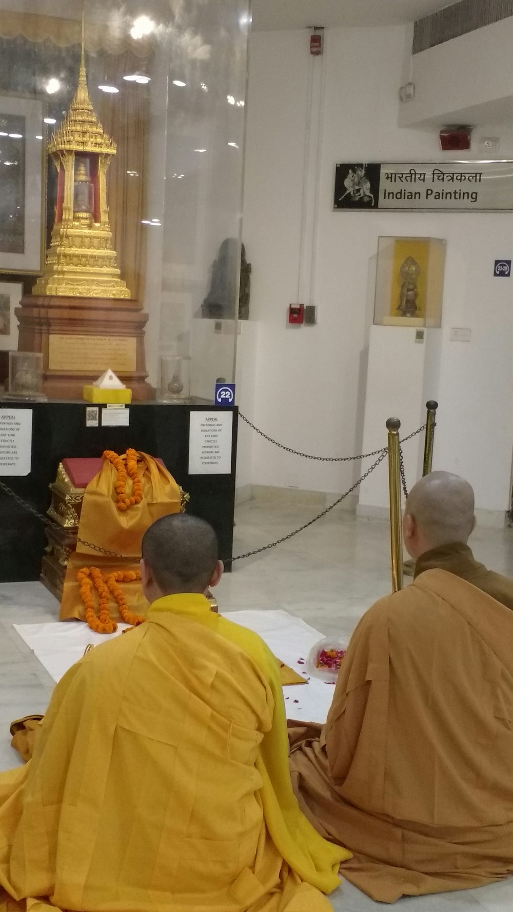 monk sitting in front of puja