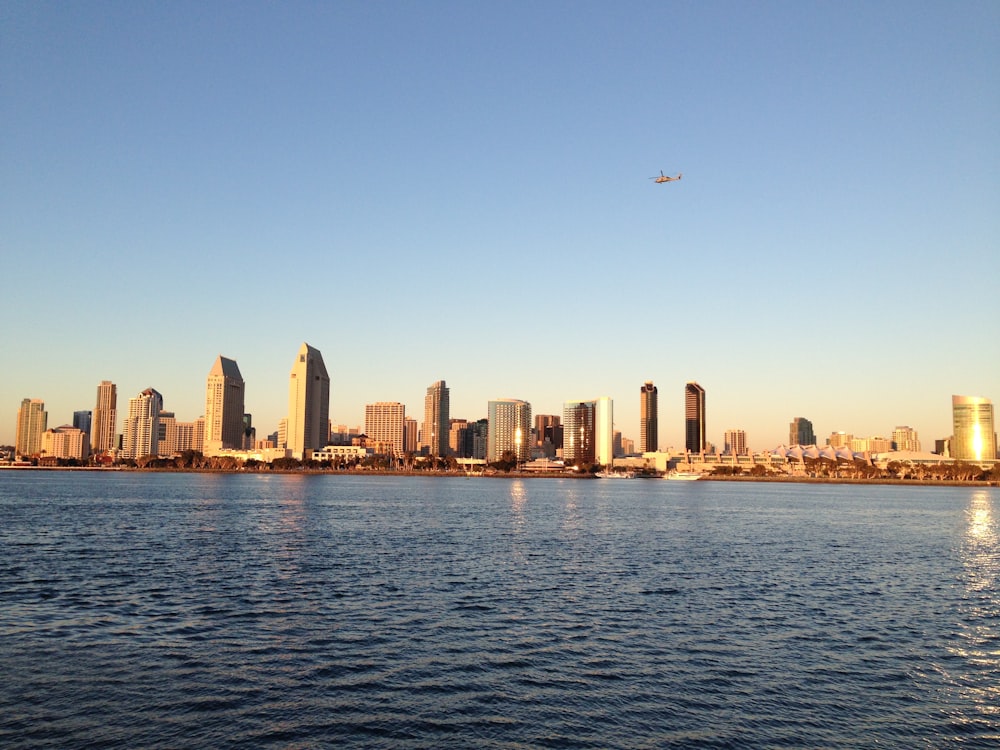 high-rise building near calm body of water