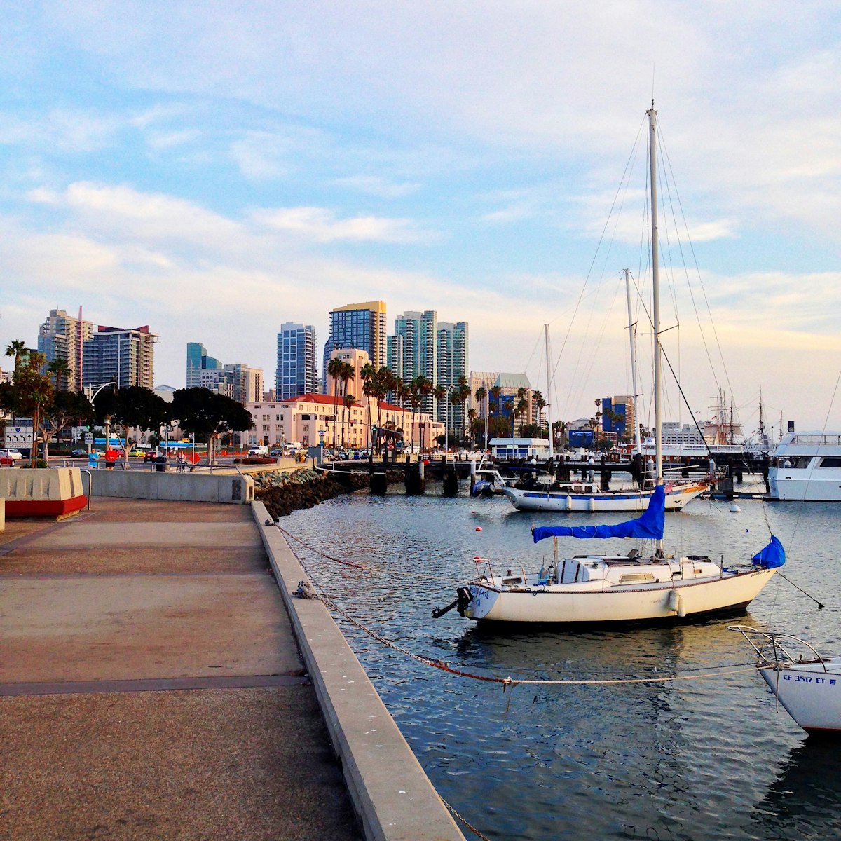 Sailboat docked at a San Diego pier with waterfront views, representing the coastal lifestyle available to NBSD families living near the bay