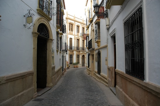 Historic Barcelona street showcasing 19th-century architecture with intricate stonework and wrought iron balconies.