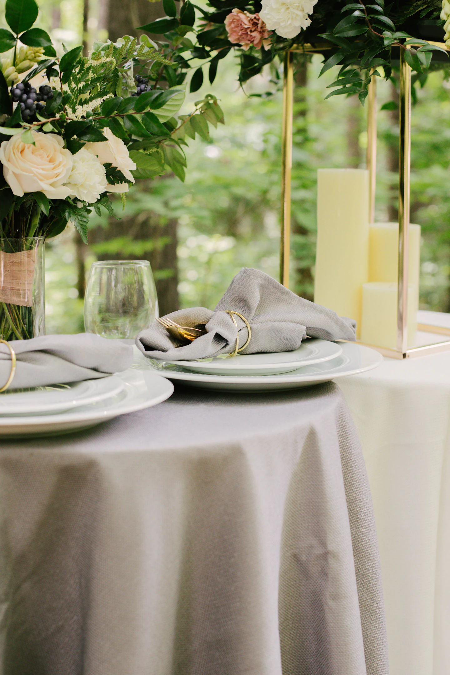 Plates and flowers arranged on a wedding reception table