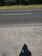 Wide shot of a team installing concrete sidewalks in a neighborhood.
