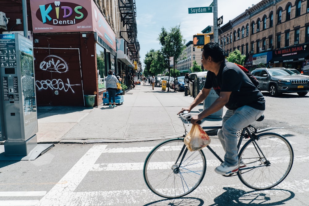 man riding bicycle during daytime