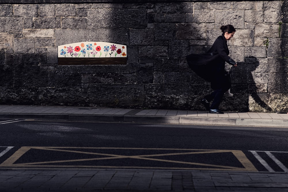 woman walking near wall