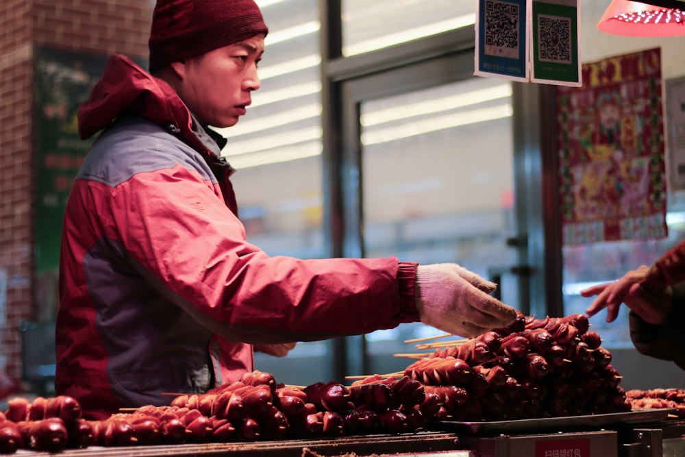 man wearing red jacket and knit cap