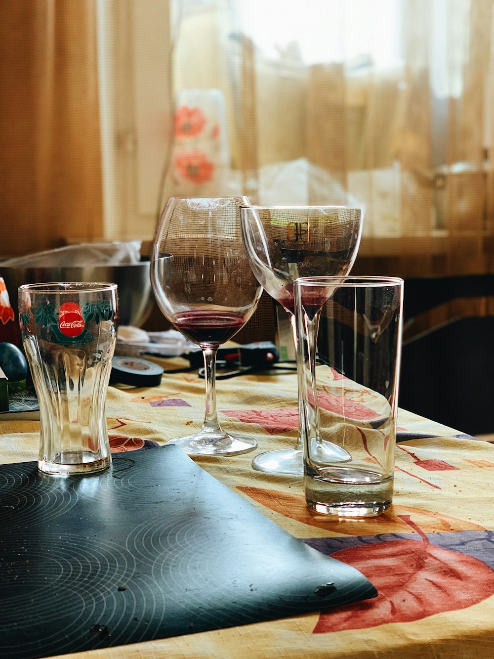 Full Clear Glass Wine Goblet Beside Two White Ceramic Vases With
