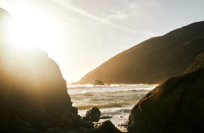 Rustic coastal cottage bathed in warm sunlight with ocean views.