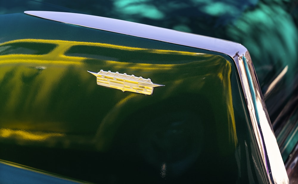 a close up of the hood of a green car