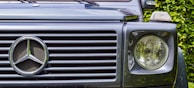 Close-up of a BYD SUV’s front grille with the logo shining under soft daylight.