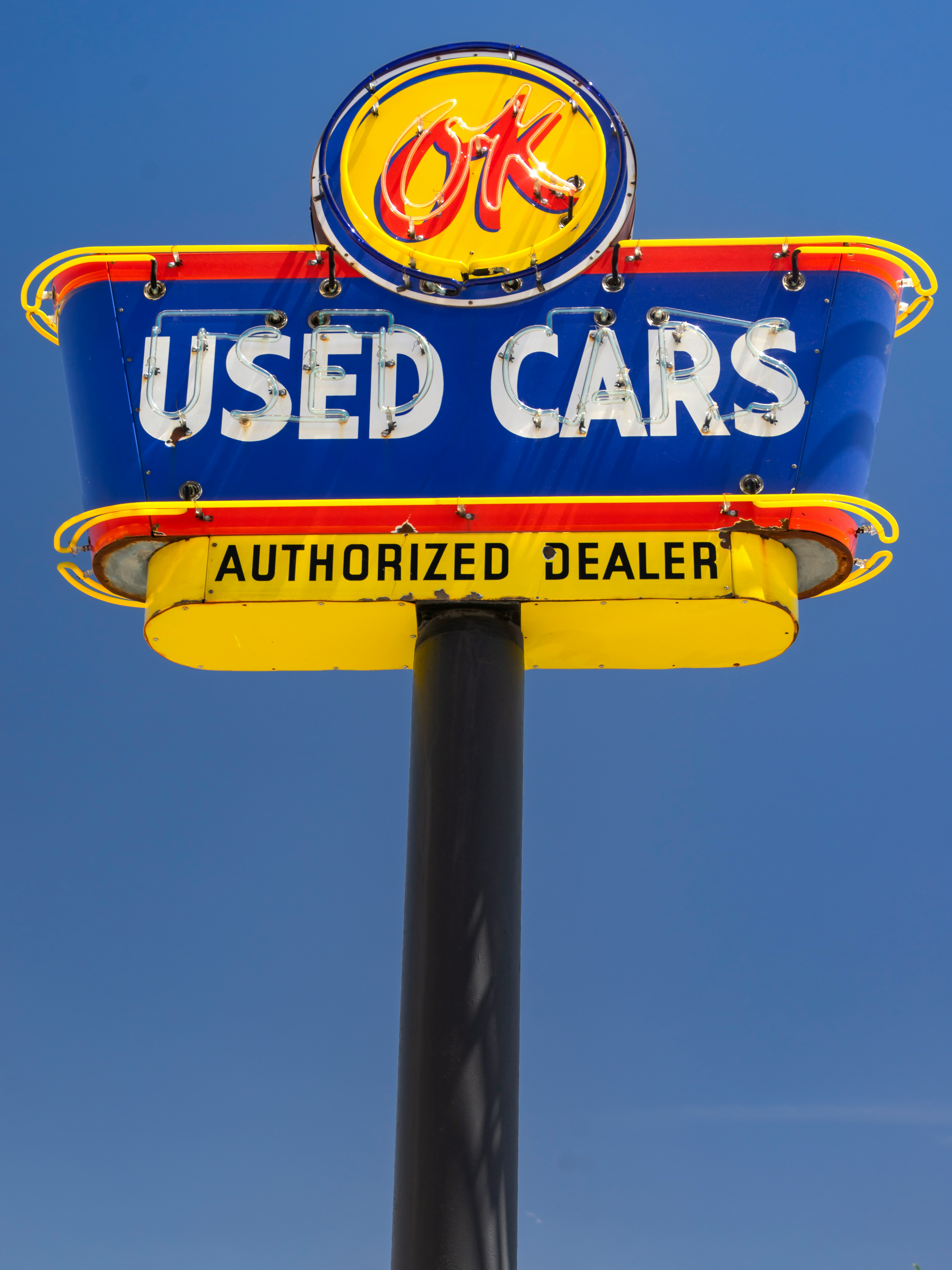 This antique sign is used by a classic car restorer to advertised their business in Kingman, Arizona.