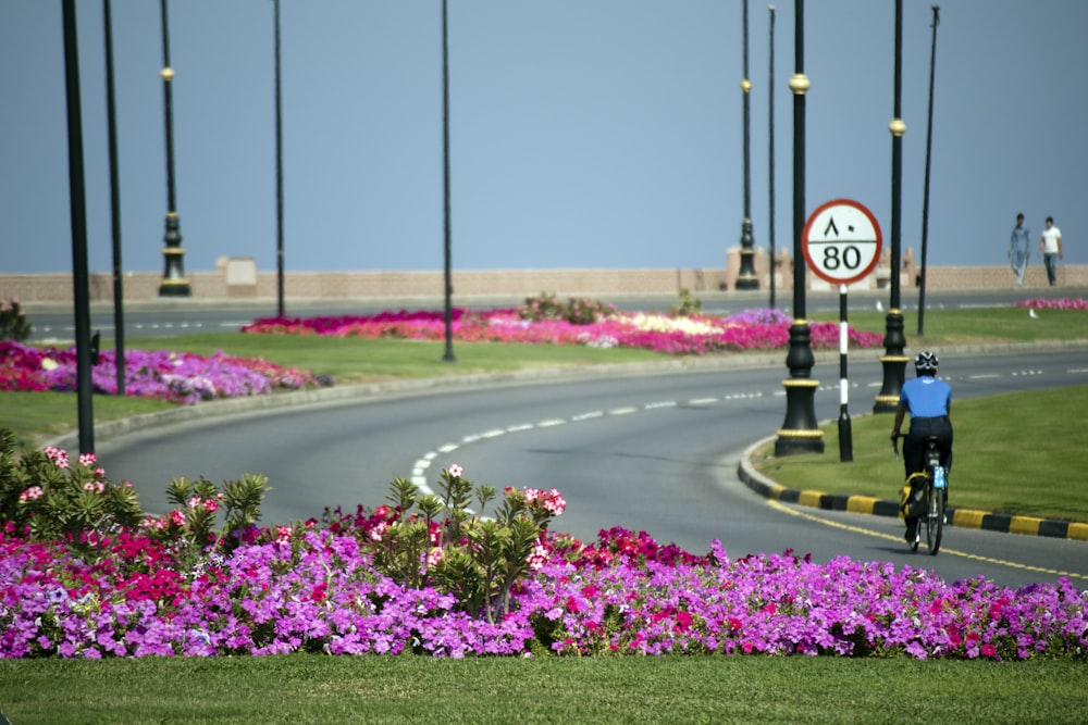 person riding bicycle on road during daytime