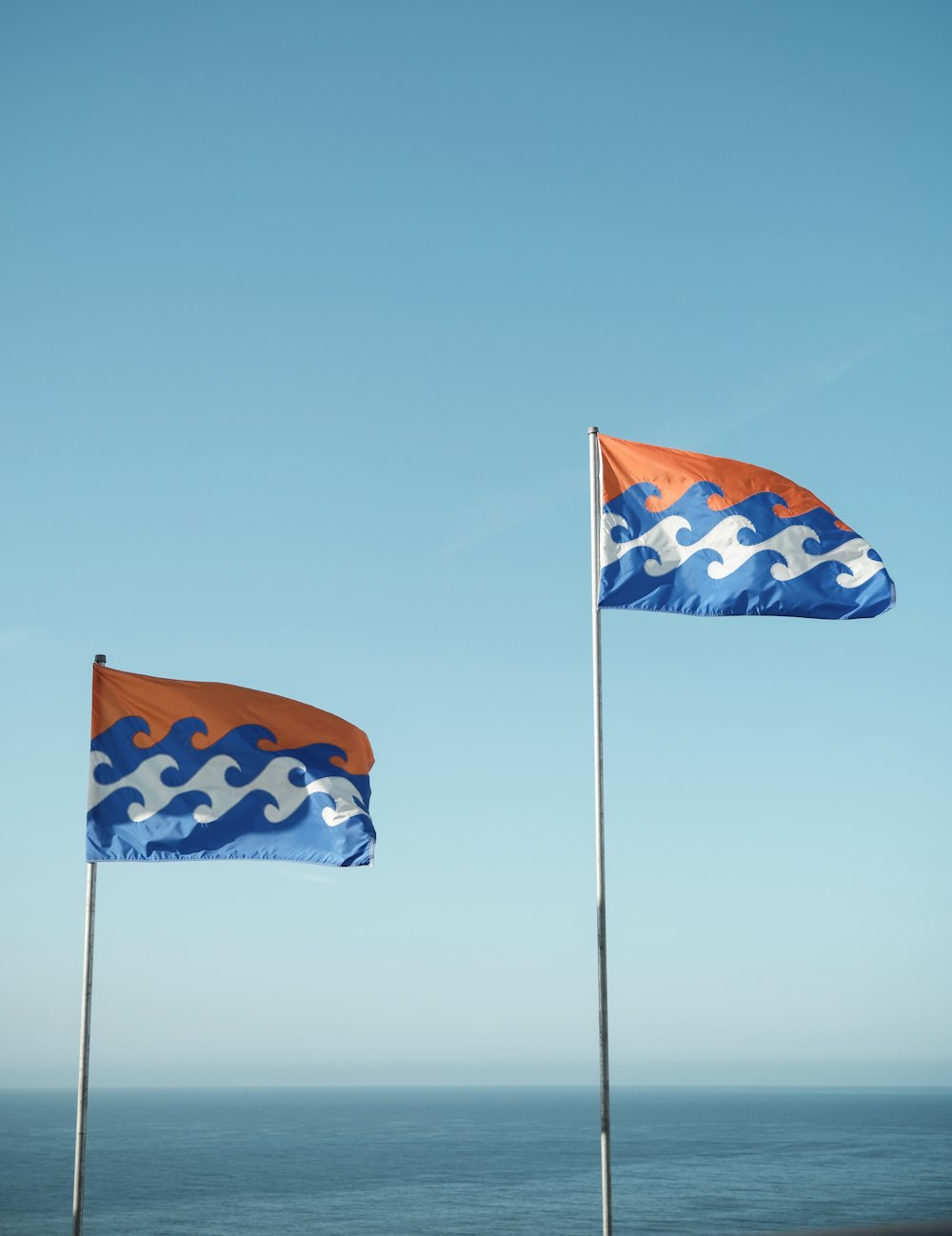 orange-white-and-blue waving flags