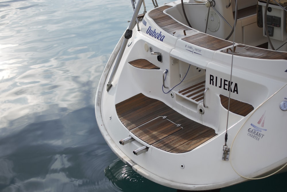 white boat on water during daytime