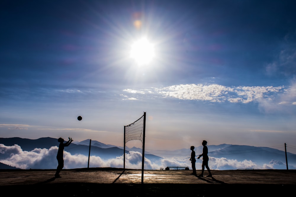 silhouette of people playing volleyball