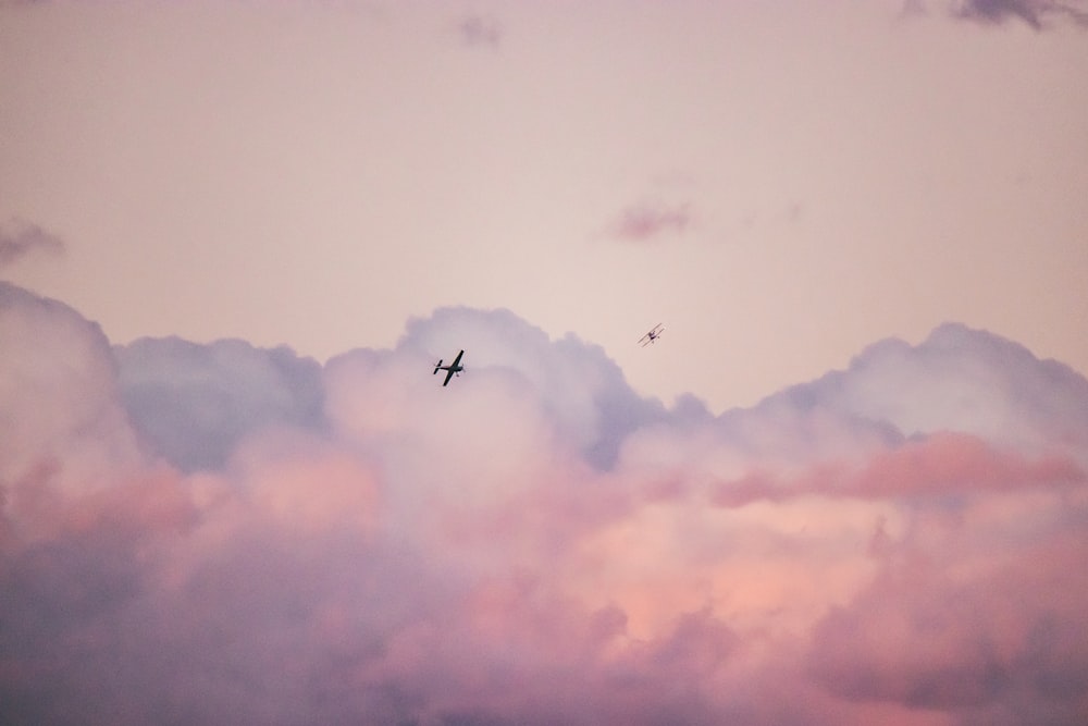 silhouette photography of airplane during flight during daytime