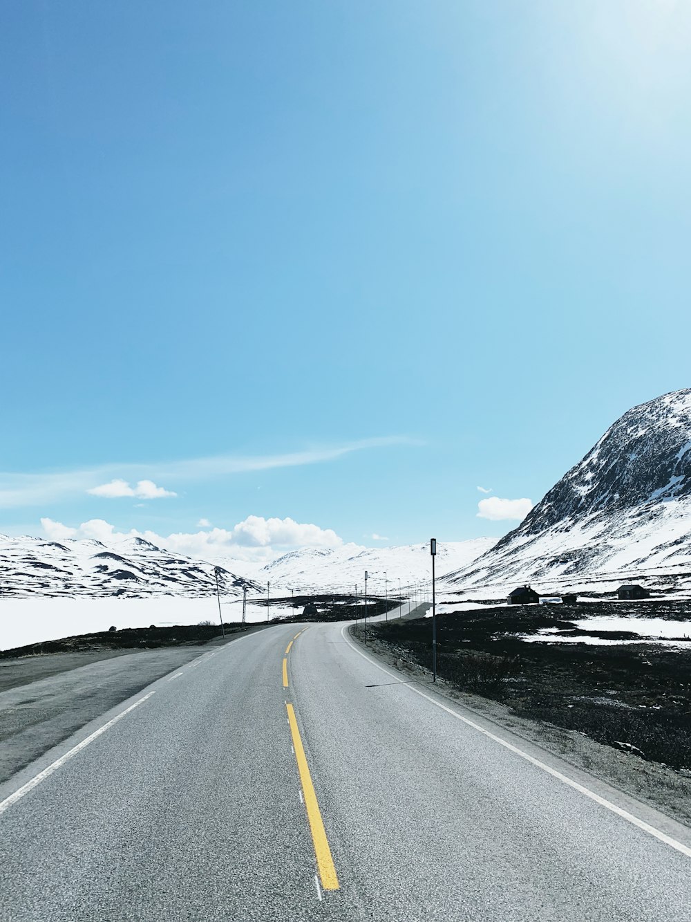 wide road under blue sky