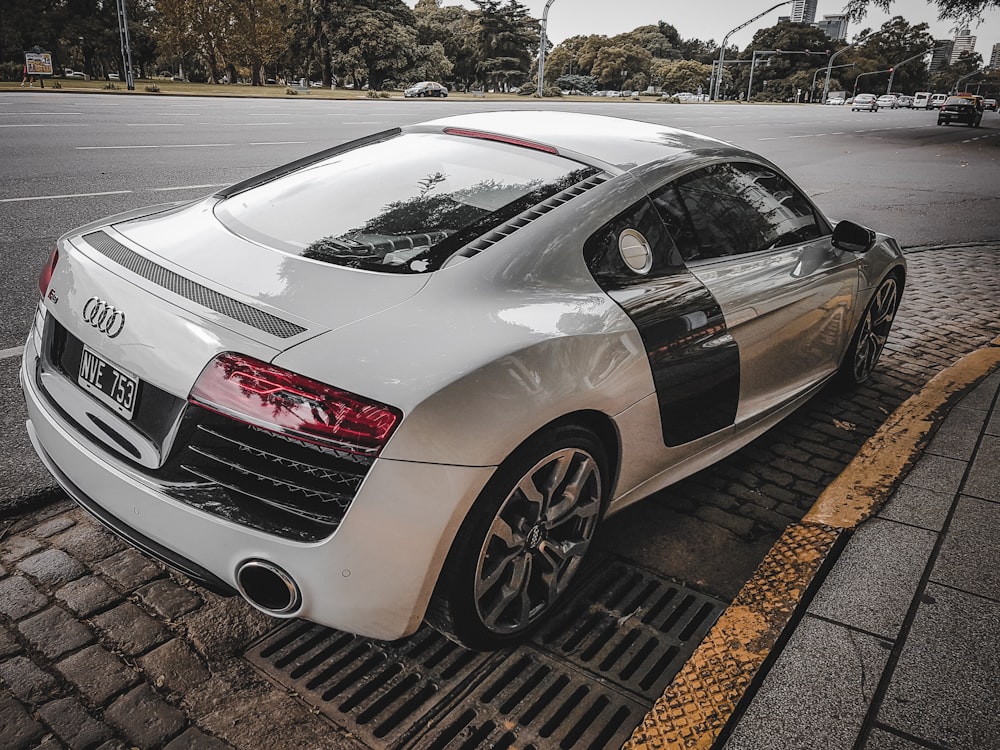 white Audi TT coupe on sidewalk