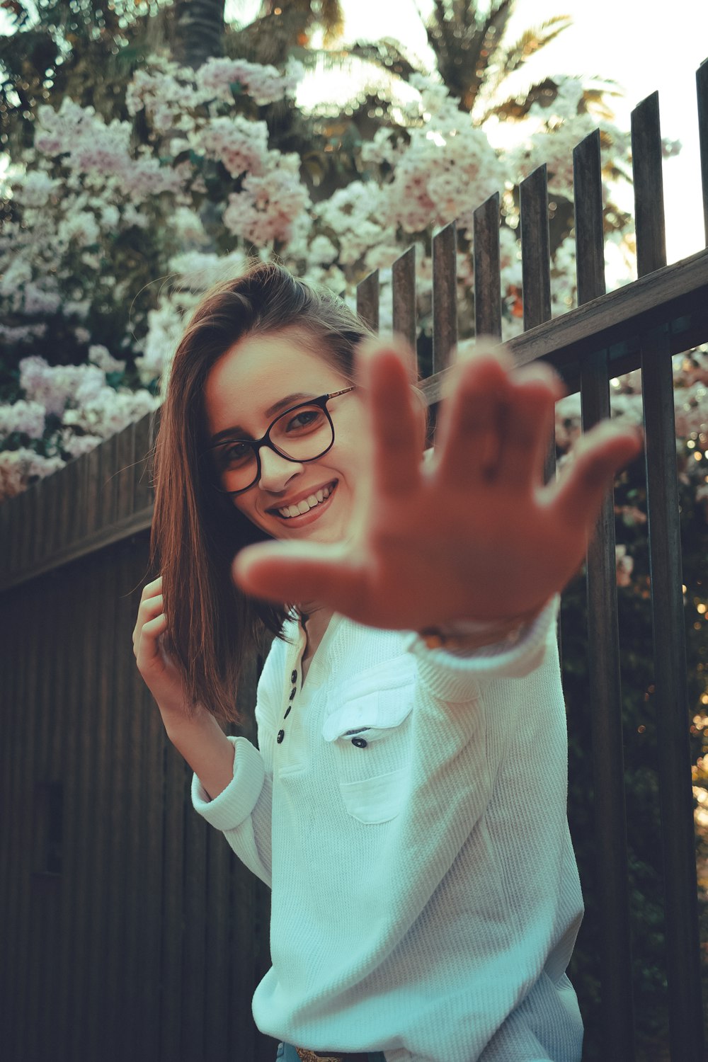 smiling woman near fence during daytime