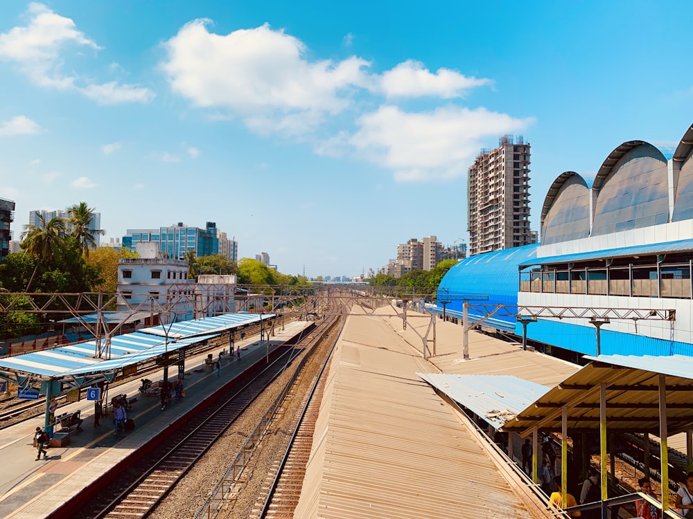 people sitting near train waiting shed during daytime