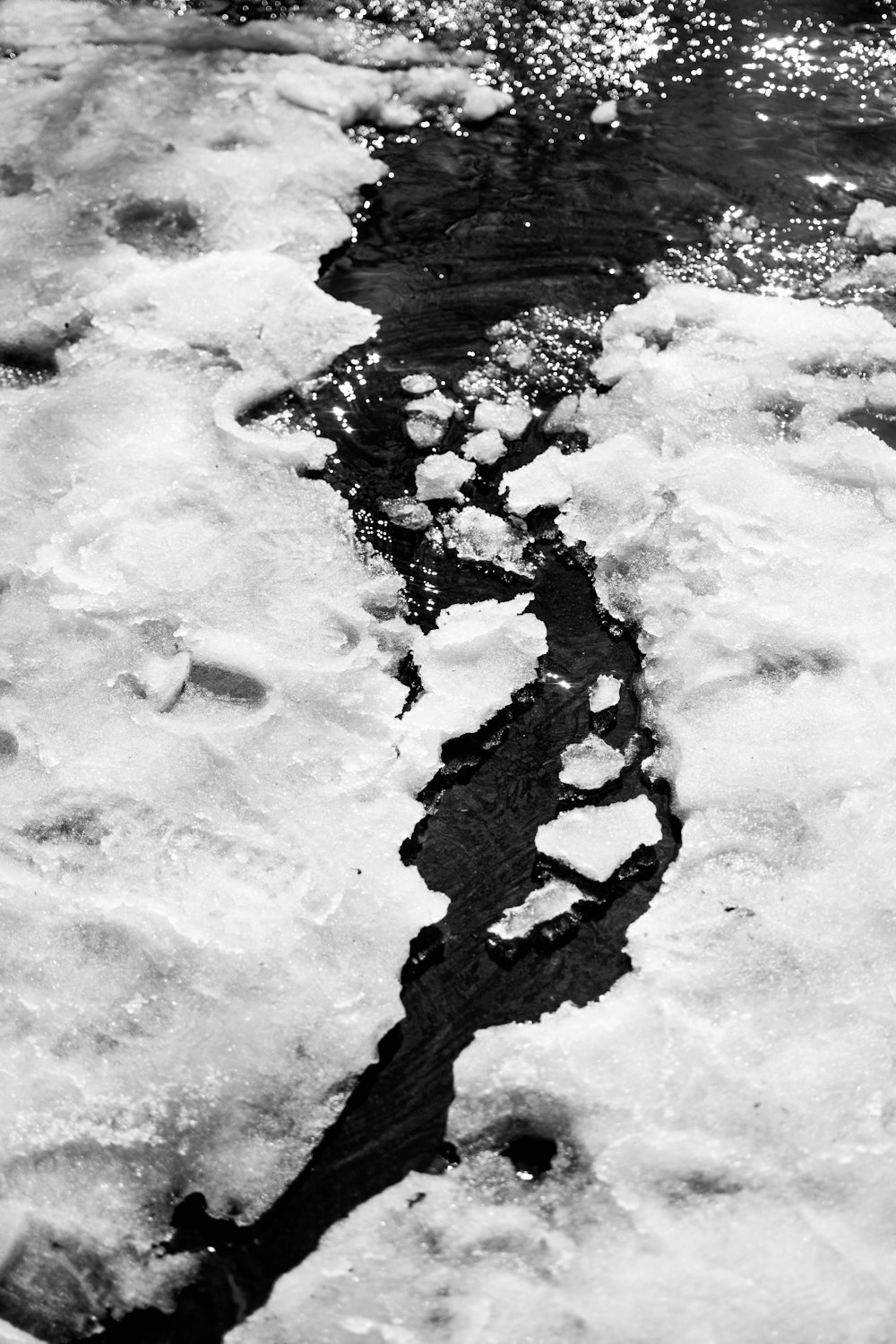 aerial photography of river and snow-covered field during daytime