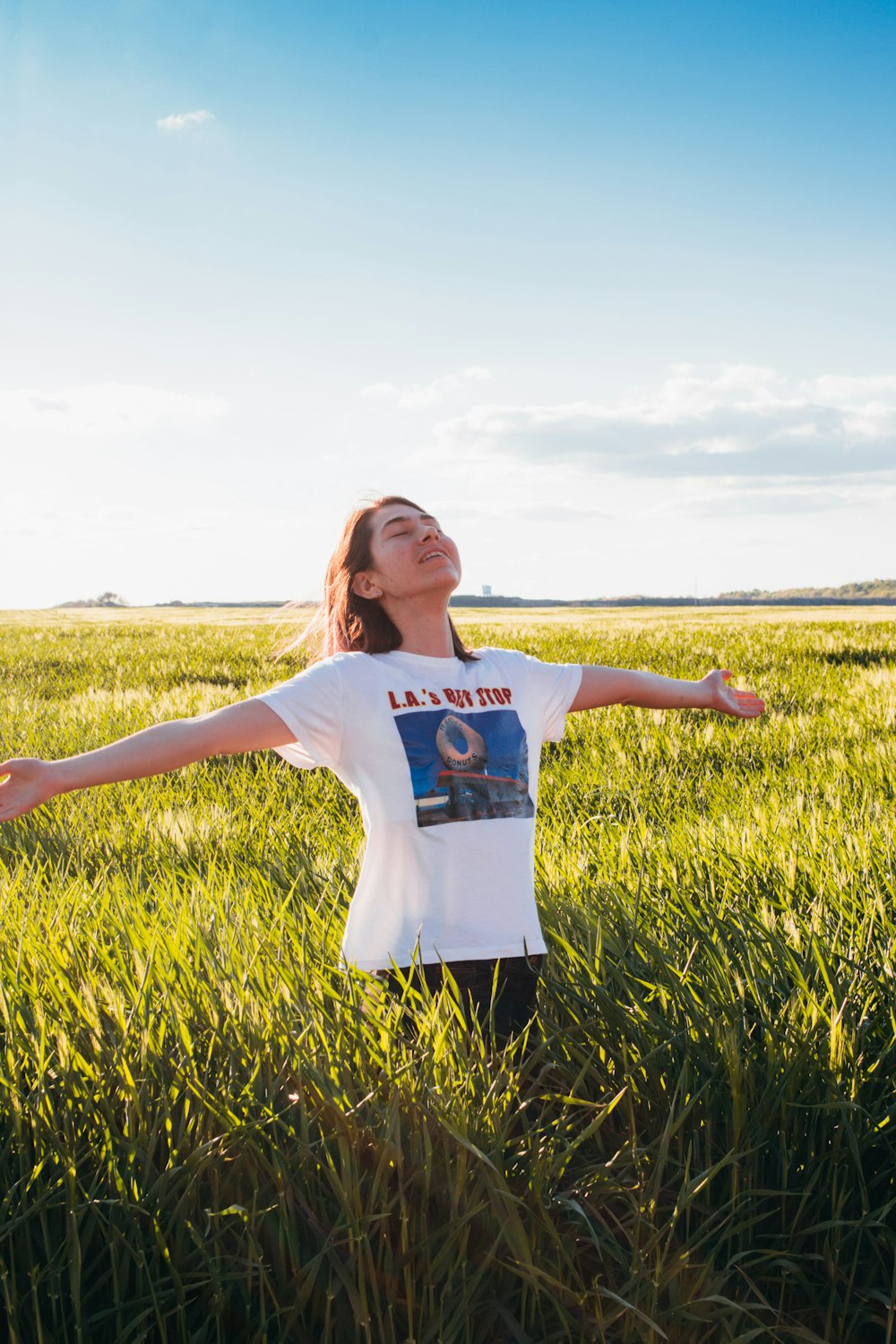 woman standing in green field