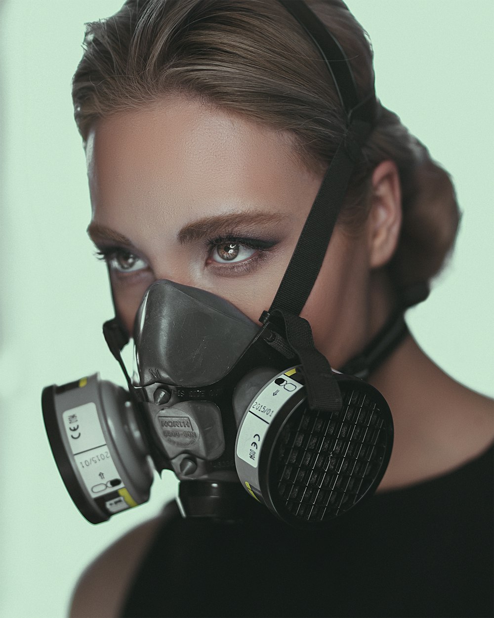 woman wearing gray respirator