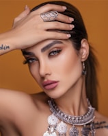 A close-up of a model showcasing exquisite jewelry and makeup.
