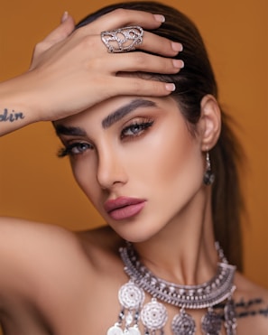 A close-up of a model showcasing exquisite jewelry and makeup.