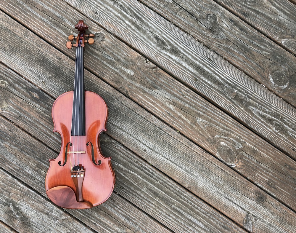 closeup photo of violin on brown surface