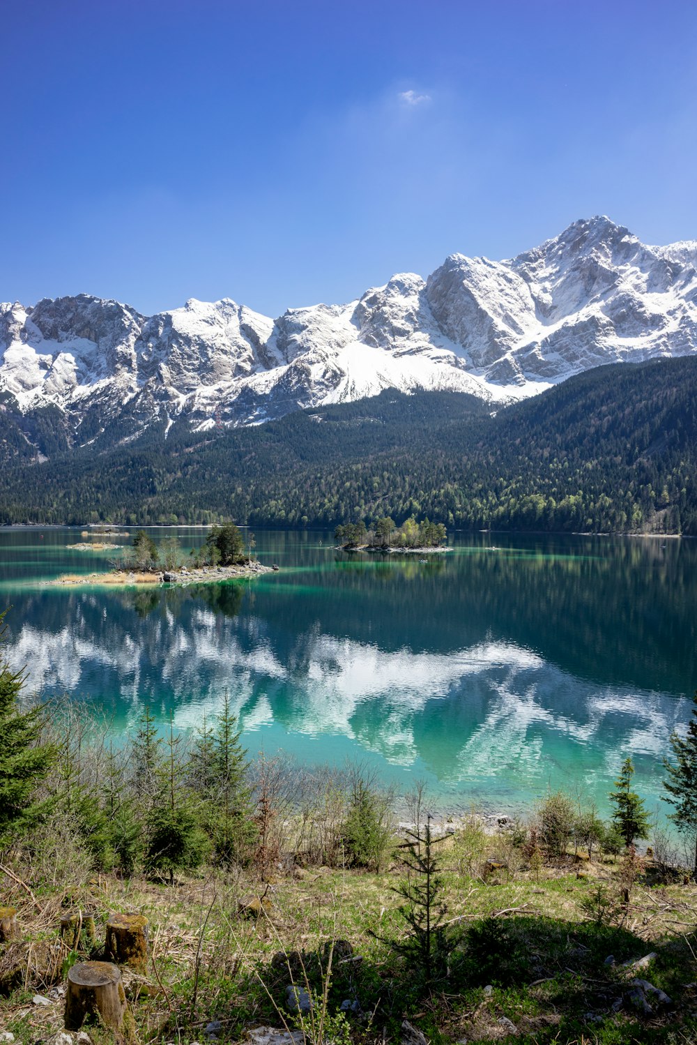 snow-capped mountains near lake during daytime