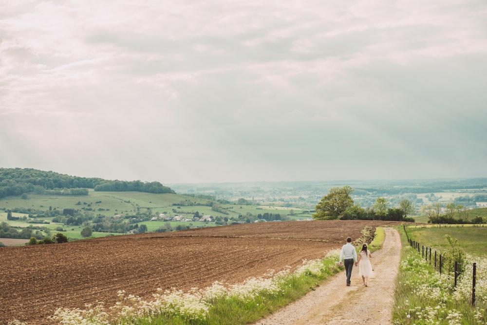 man and woman walking on road during daytime