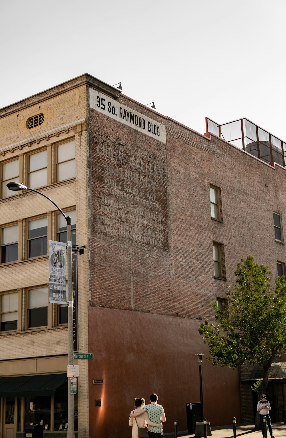 two person walking while holding near building