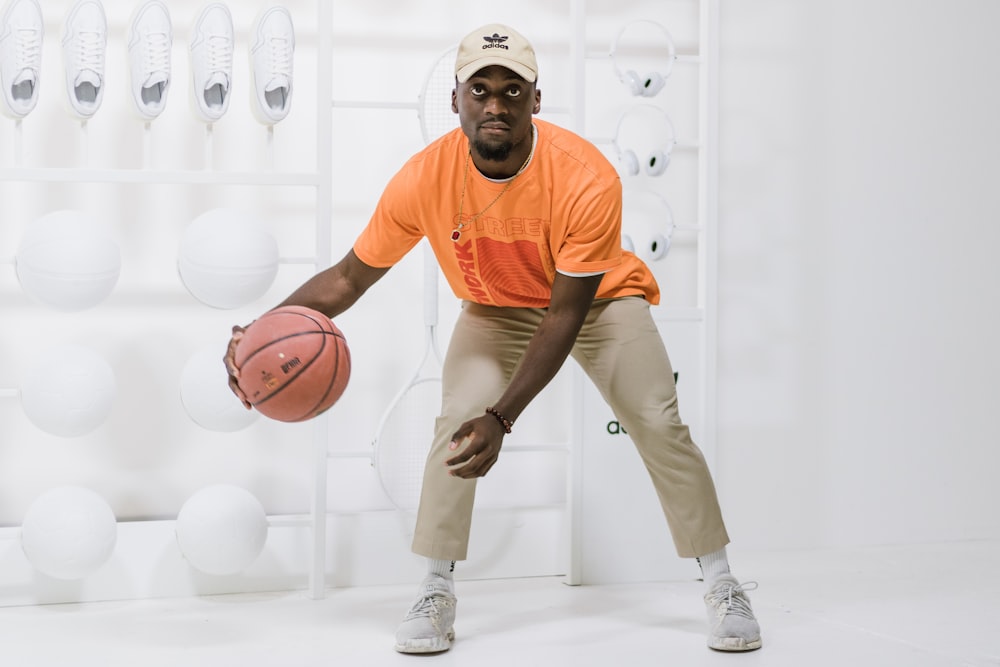 men's orange crew-neck t-shirt and brown pants