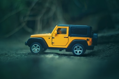 selective focus photography of yellow and black vehicle