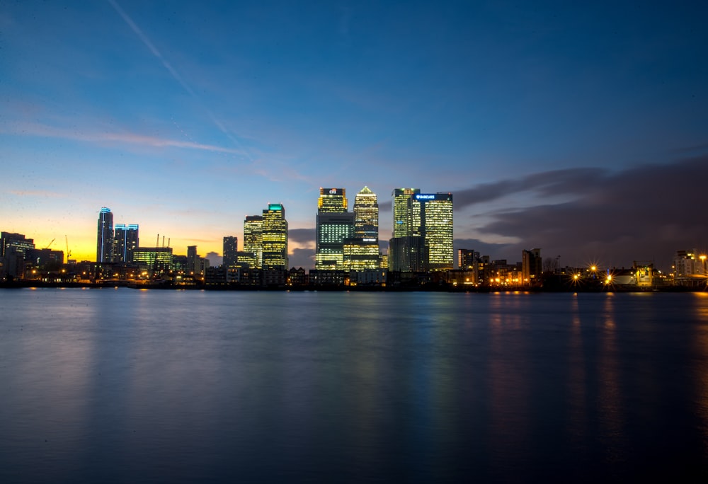 lighted city near body of water during golden hour